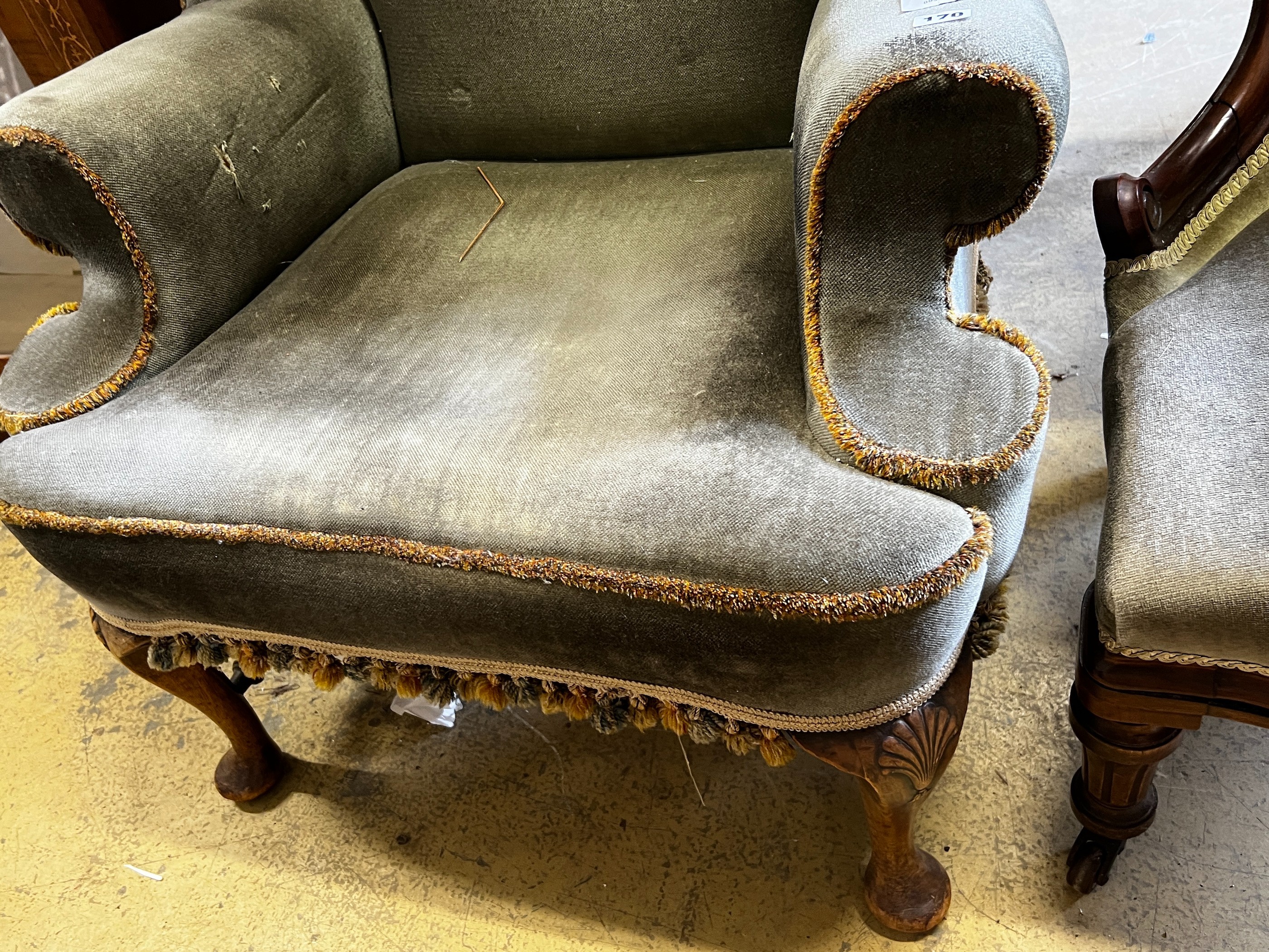 A Queen Anne revival upholstered wing armchair, width 71cm, depth 62cm, height 110cm